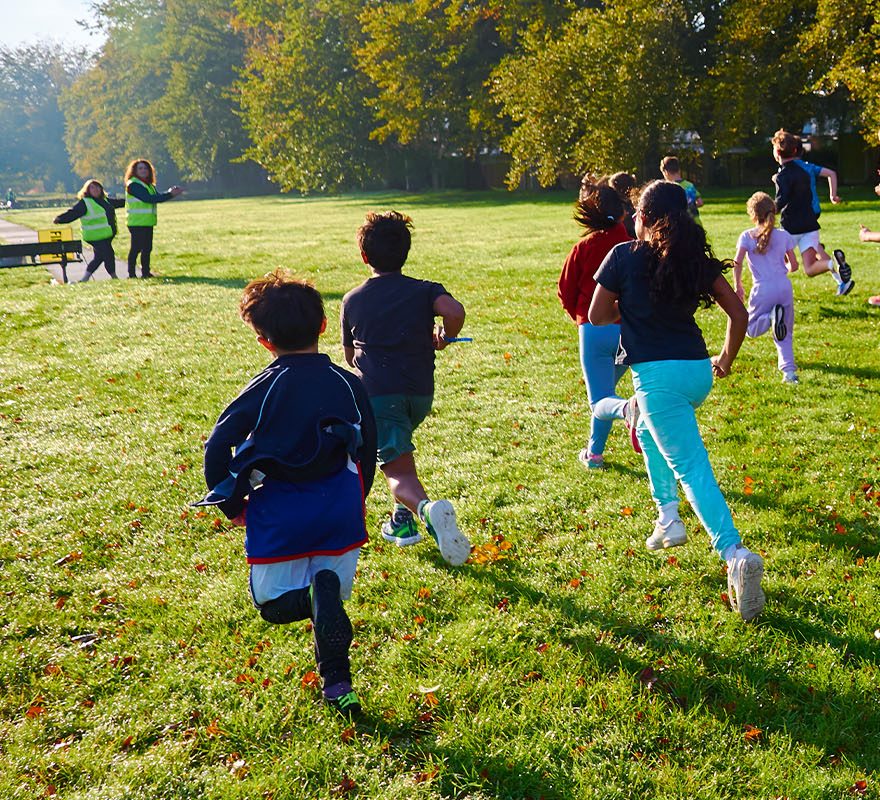 Children running under supervision by an adult
